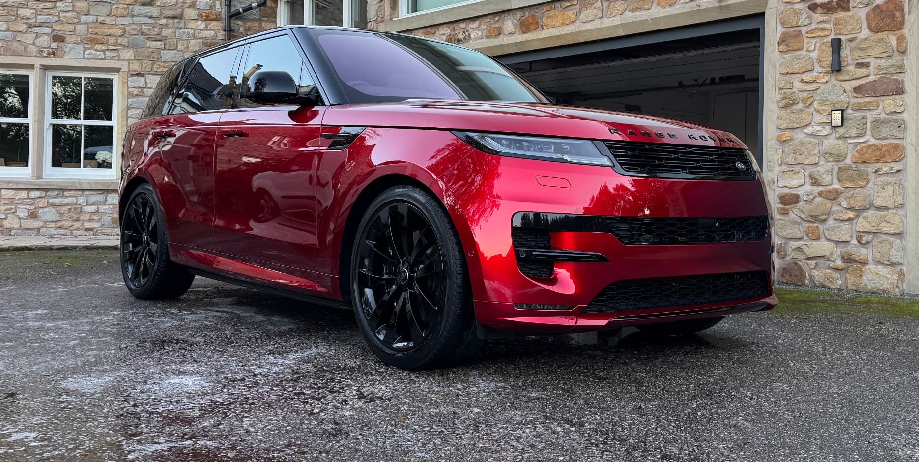 Red Range Rover Sport with a fresh gloss finish on a customer driveway